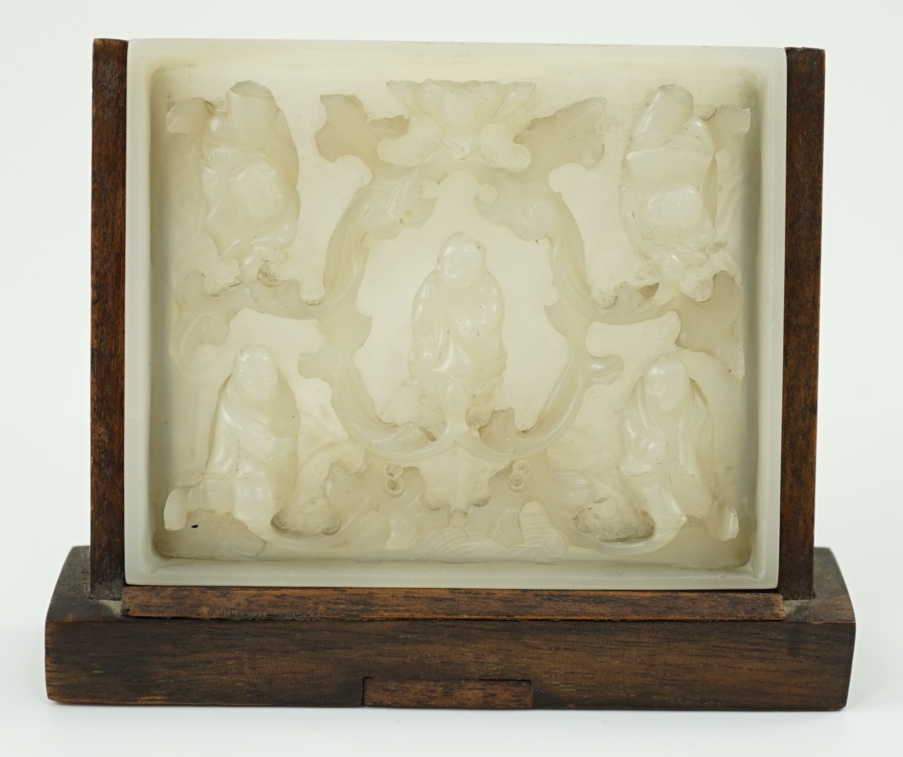 An unusual Chinese white jade plaque, 18th/19th century, 6.7cm x 8.1cm, wood stand